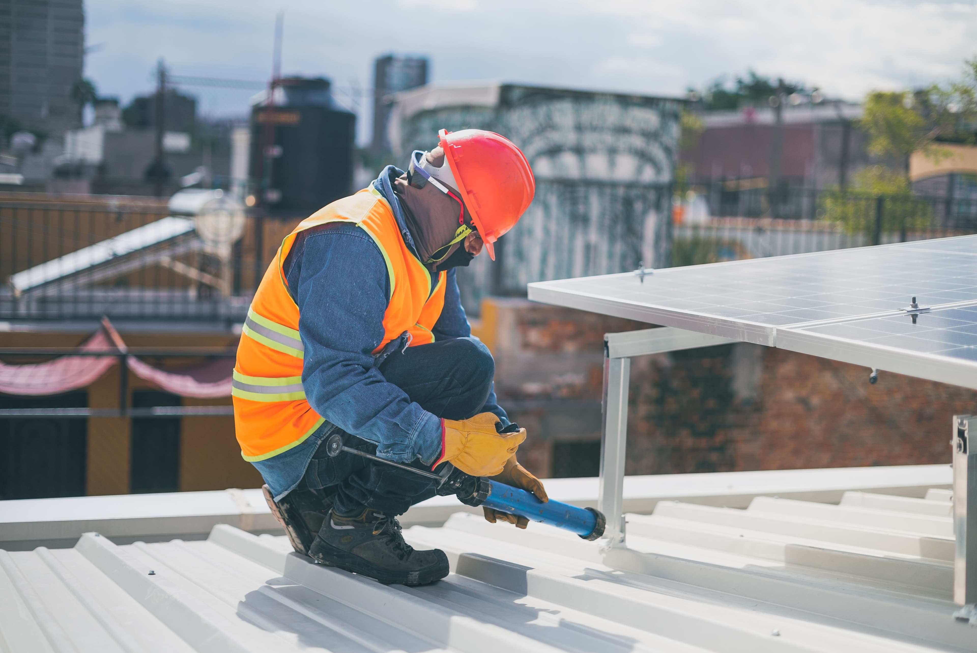 Vakman installeert zonnepanelen op een dak